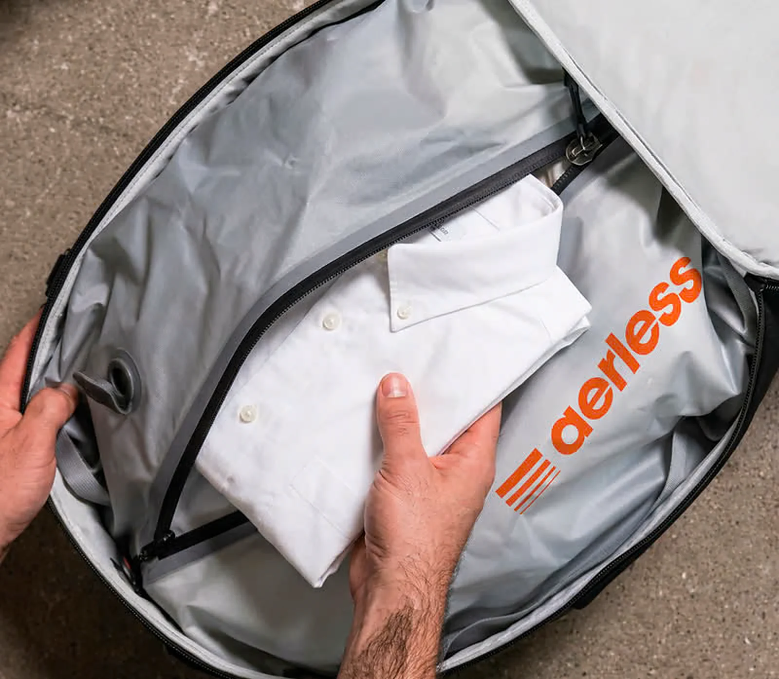 Aerless compression bags packed inside a suitcase next to folded sweaters